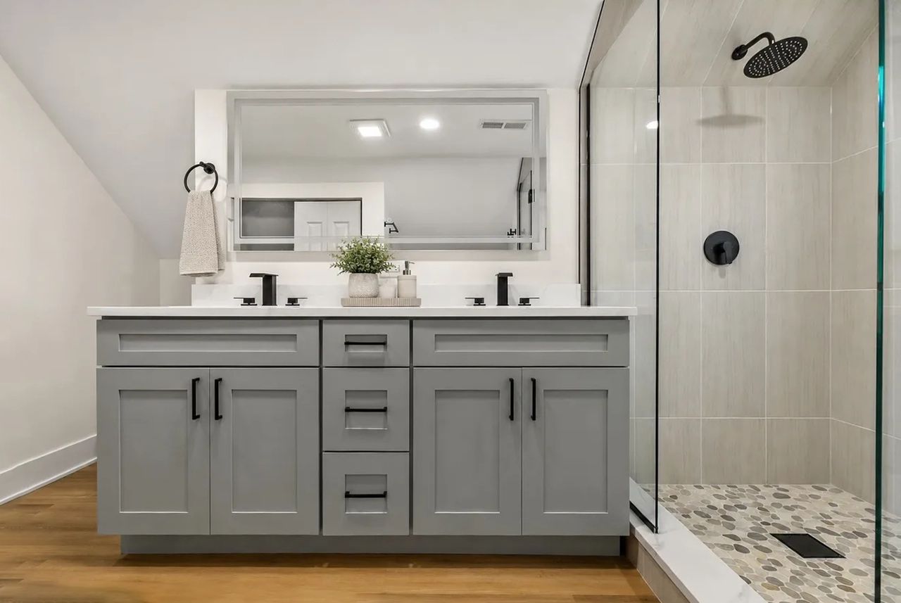 Primary bathroom with a double vanity and walk-in shower