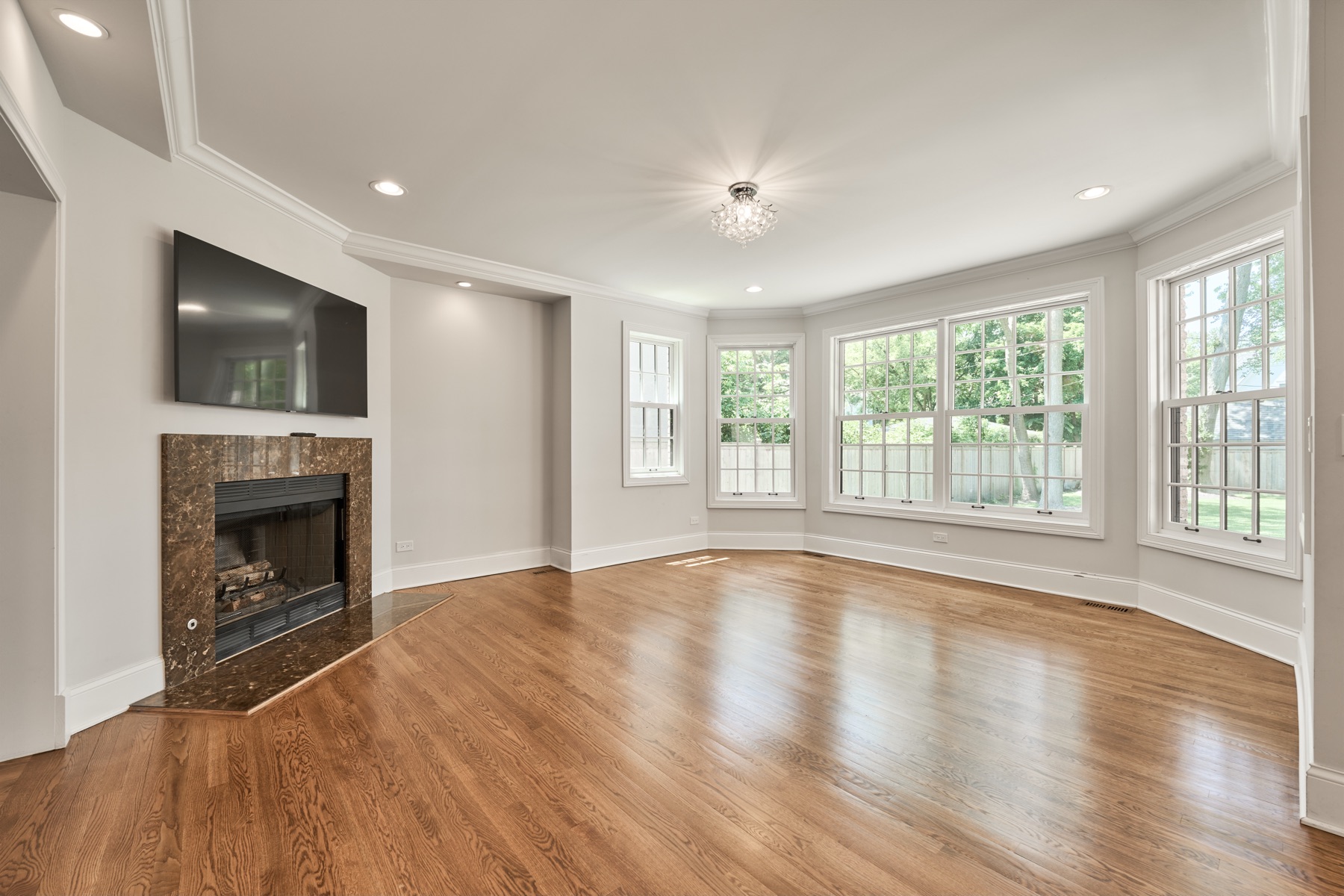 Living room with a marble fireplace and bay window